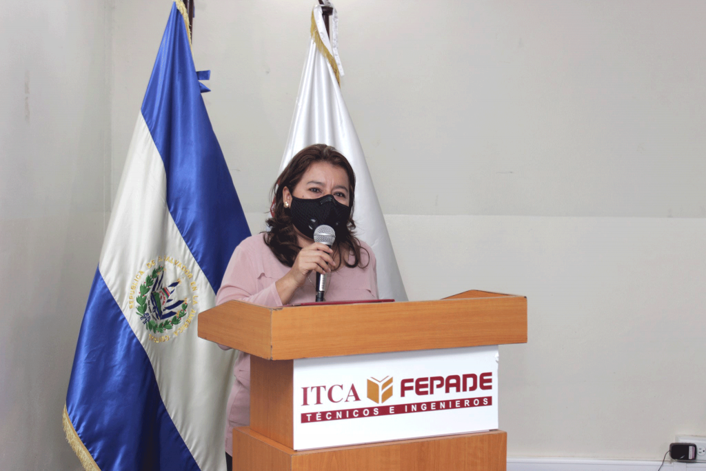 Betsy de Cosme speaks at a podium.